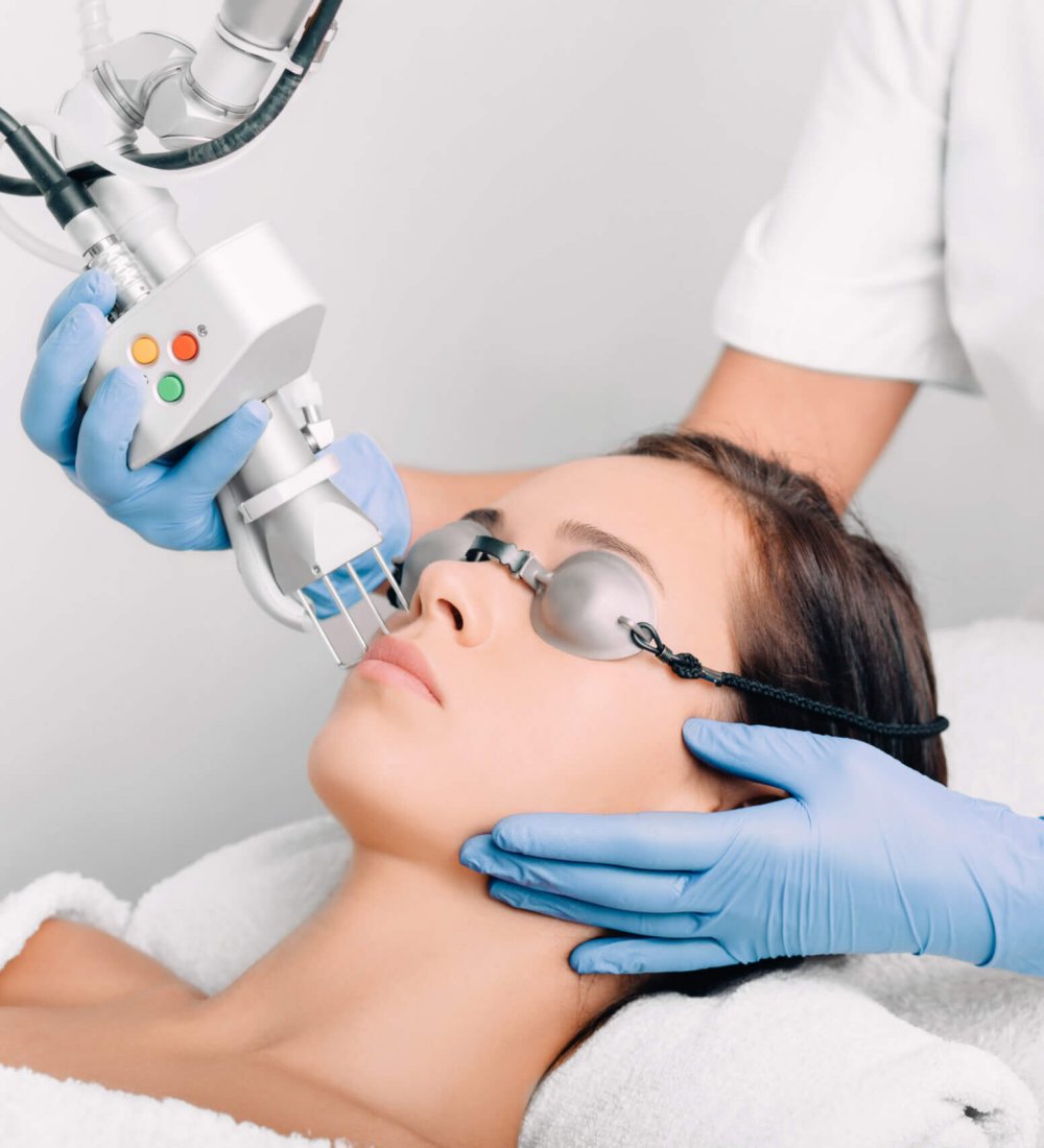 woman wearing protective glasses, getting laser facial treatment. Facial skin rejuvenation